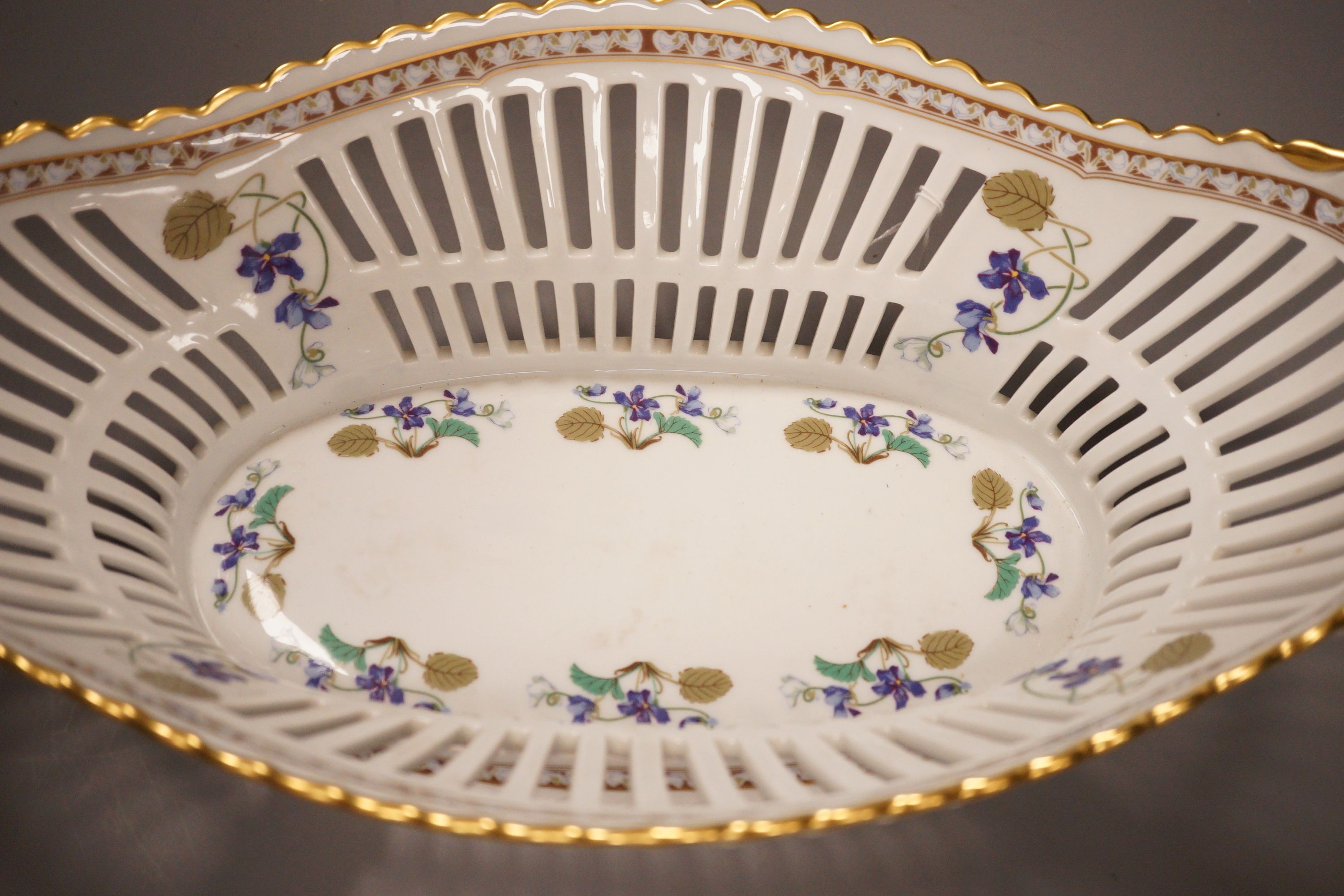 A Haviland Limoges fruit basket, painted with trailing flowers, 41cm